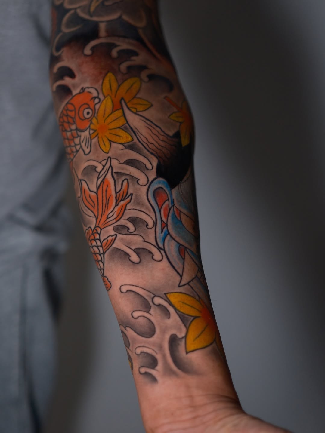 Japanese-Inspired Koi & Wave Sleeve Tattoo