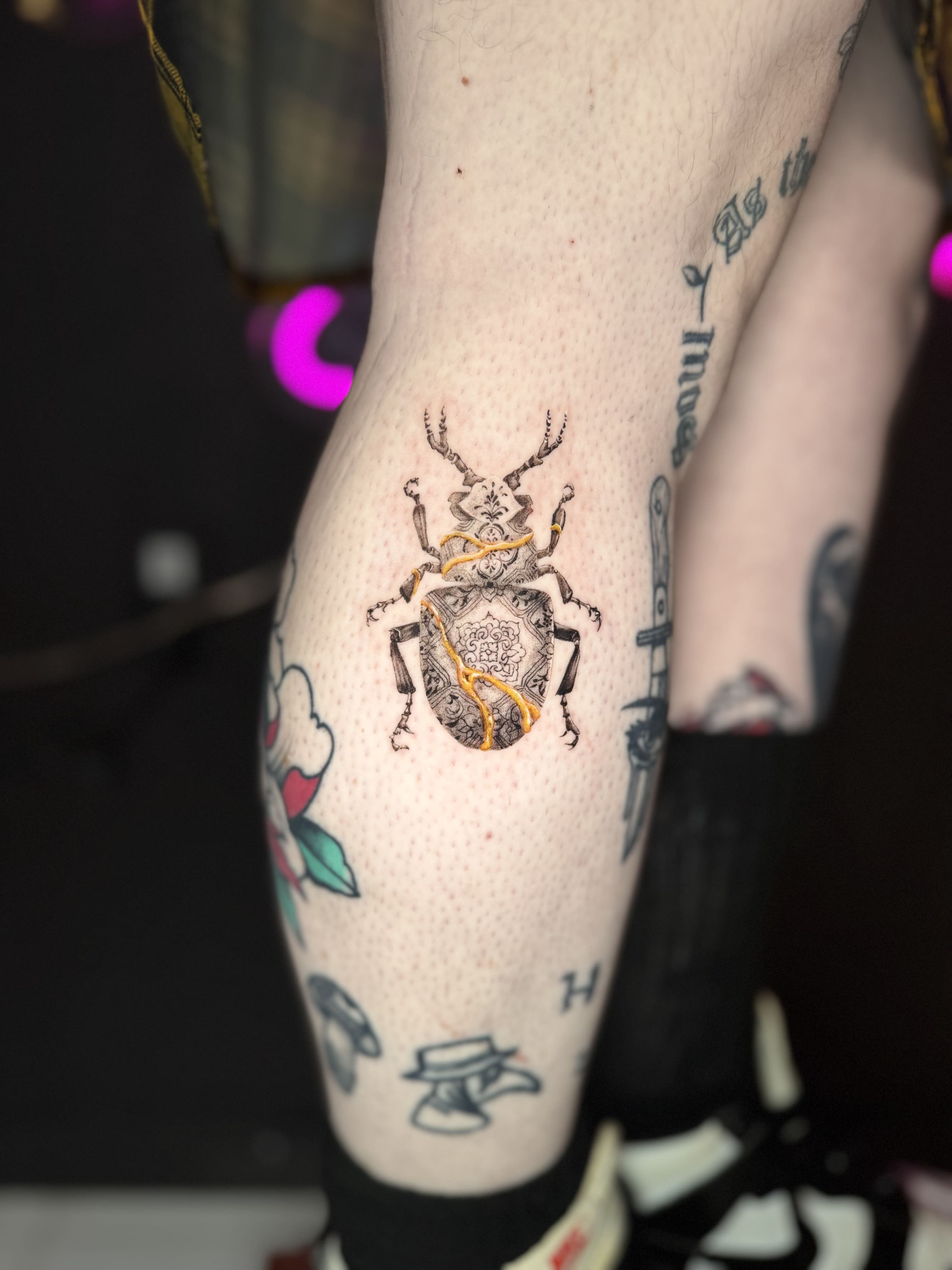 Ornamental Beetle Micro Tattoo with Gold Accent