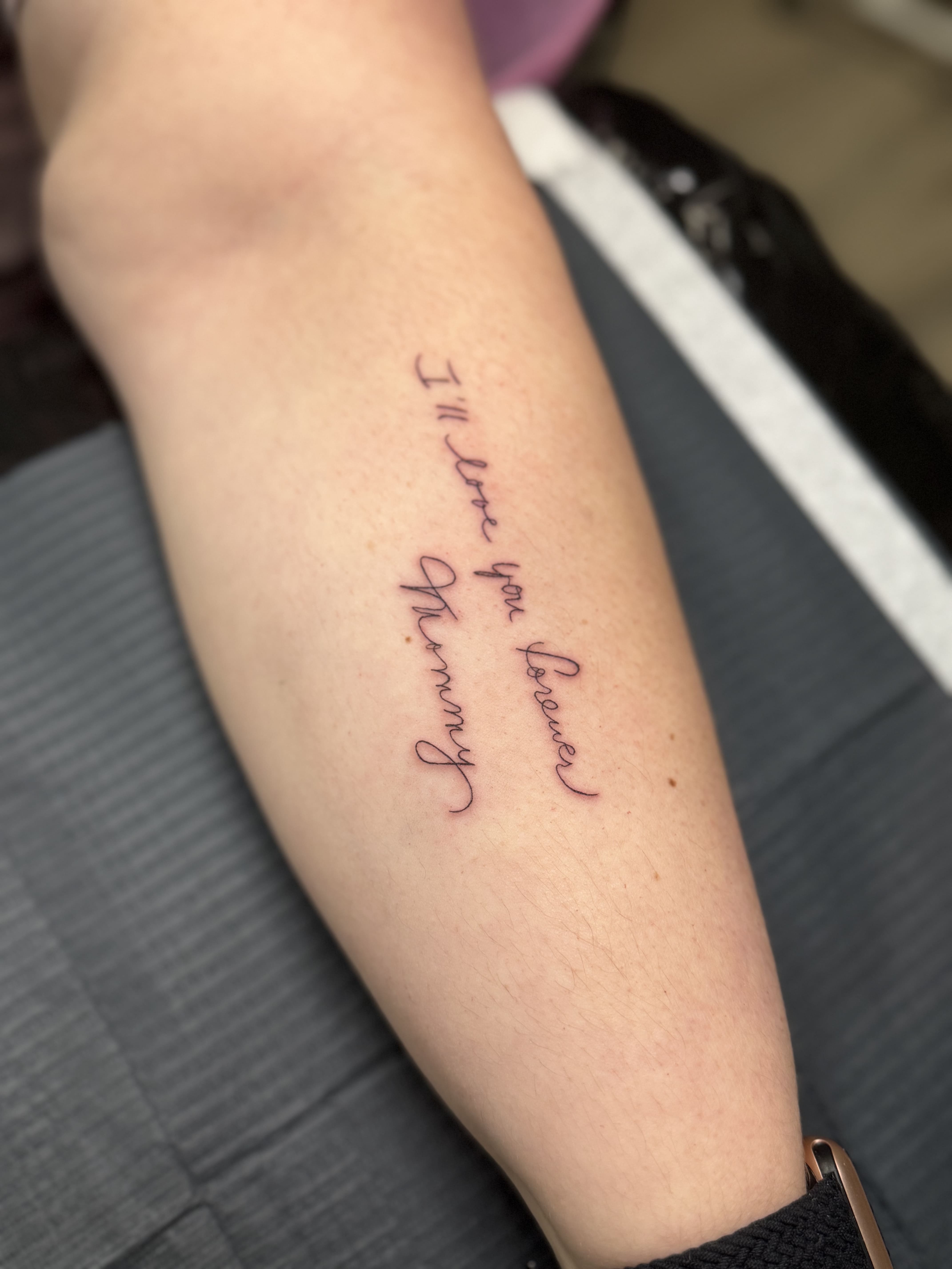 Fine Line Script Quote Tattoo — “I’ll love you forever, Mommy”