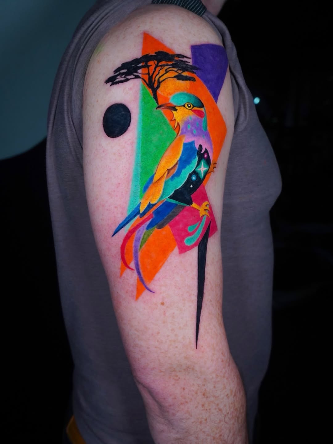 Vibrant Geometric Cosmic Bird Tattoo