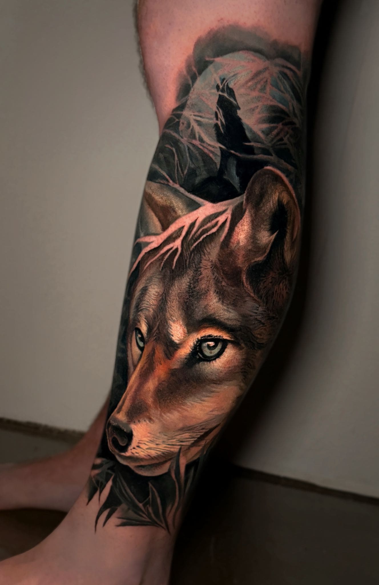 Realistic Wolf Forearm Tattoo with Forest Silhouett