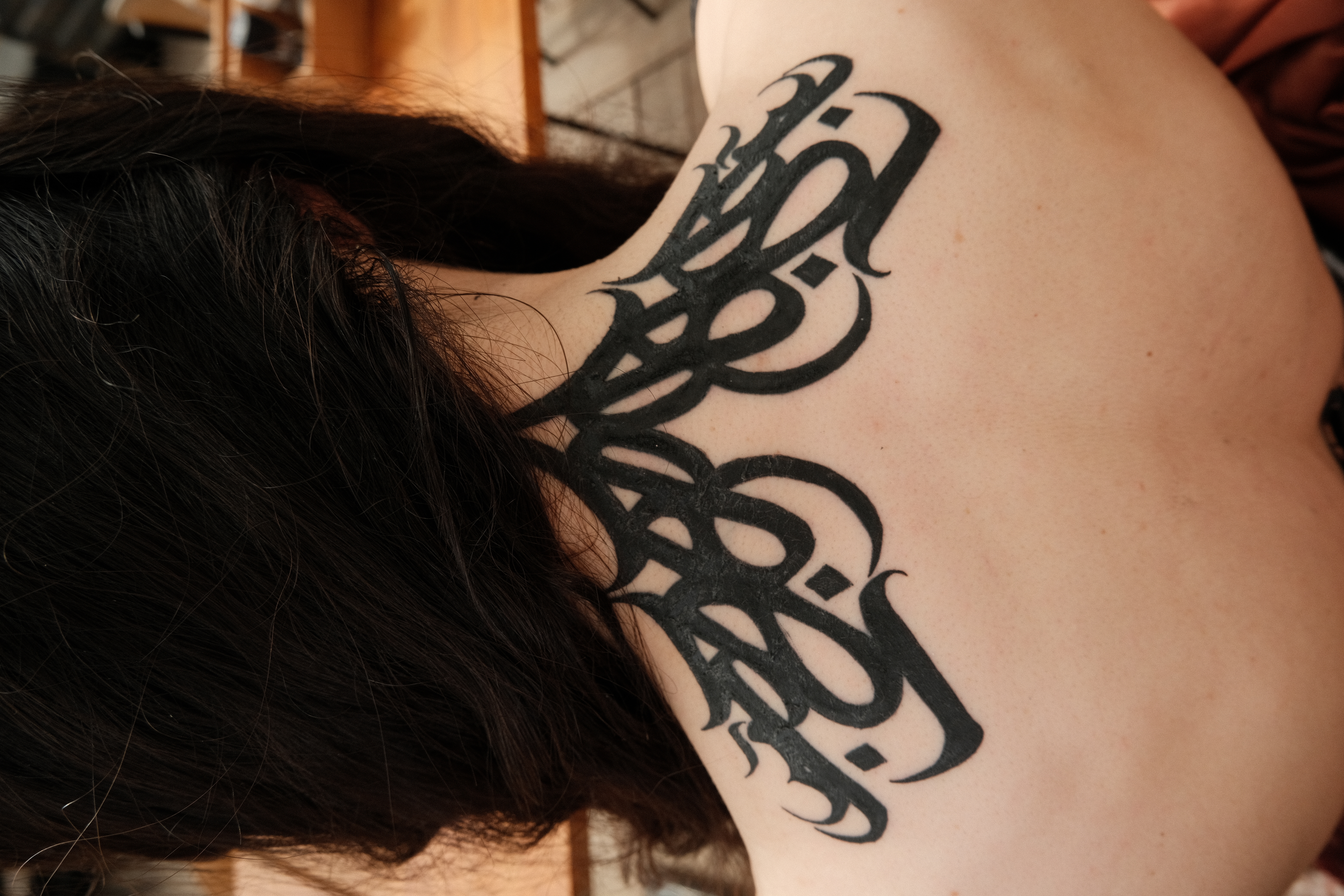 Calligraphic Ornamental Neck Tattoo