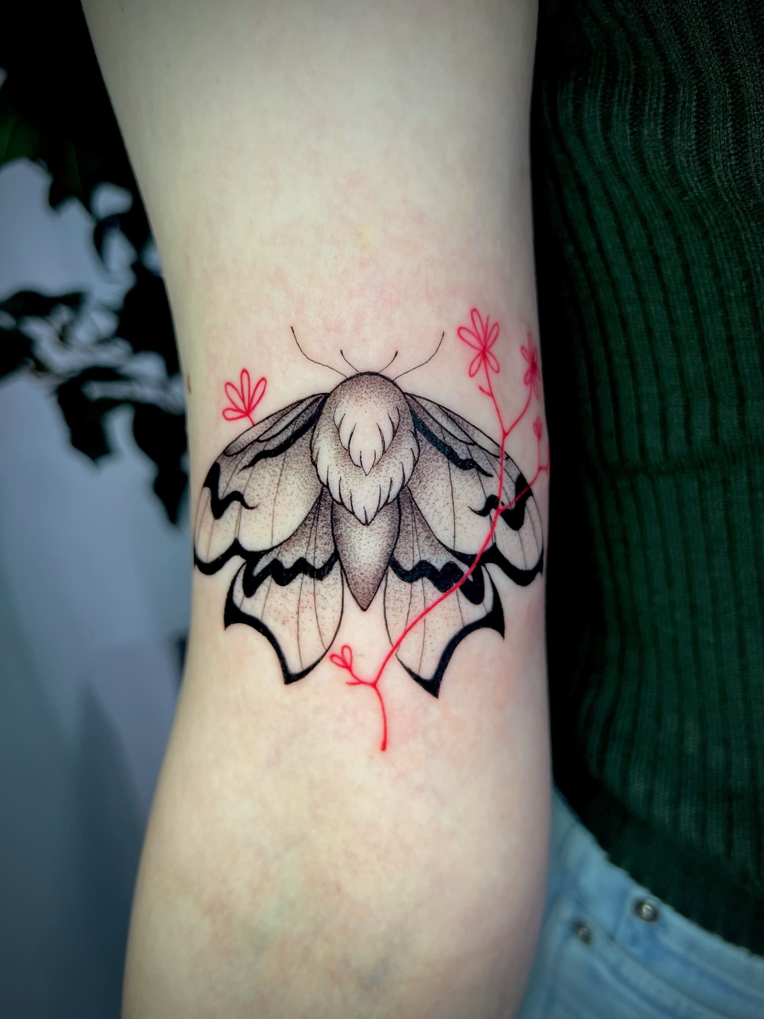 Fine Line Moth with Red Floral Accent Tattoo