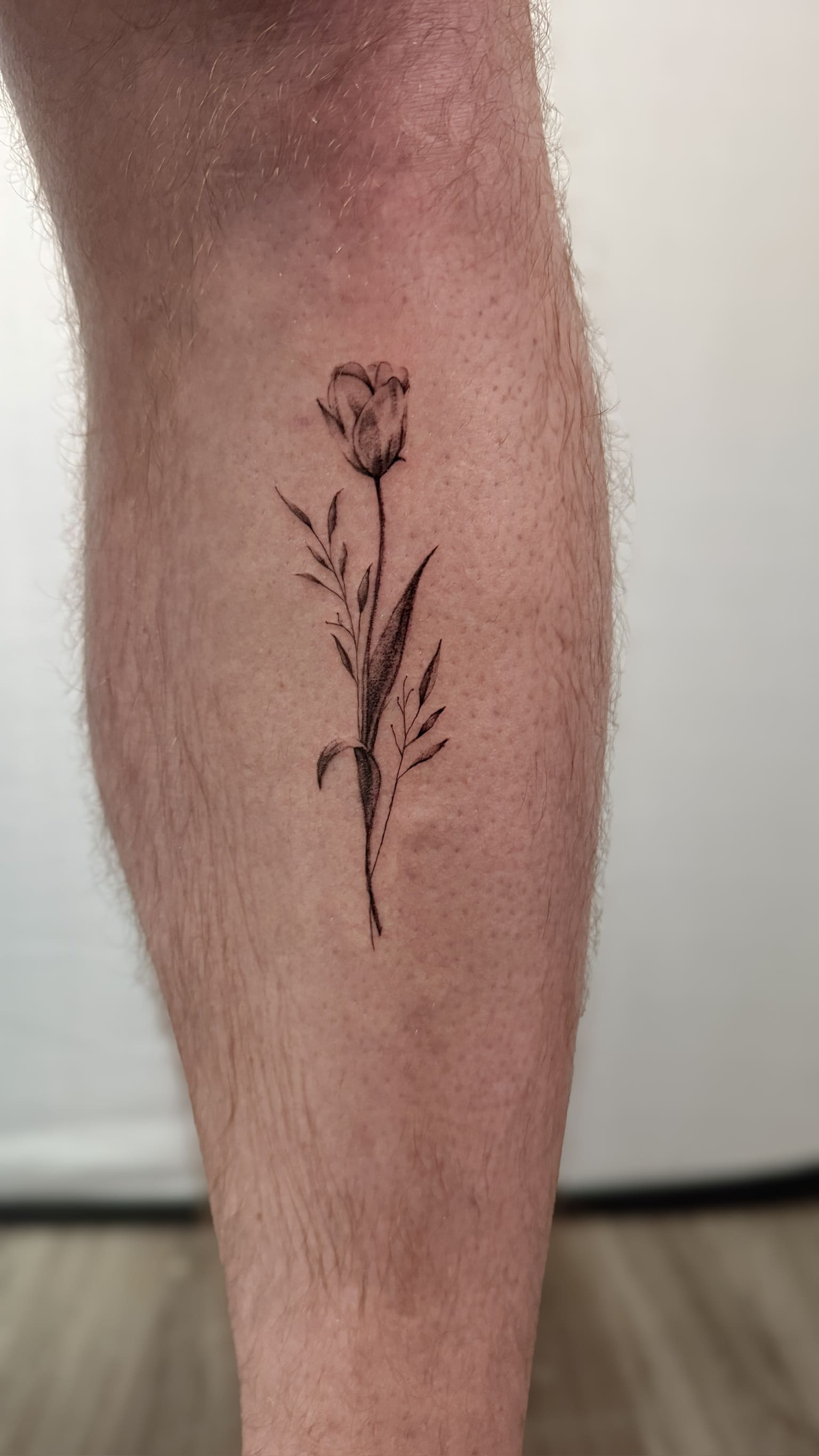 Elegant Tulip Fine Line Tattoo