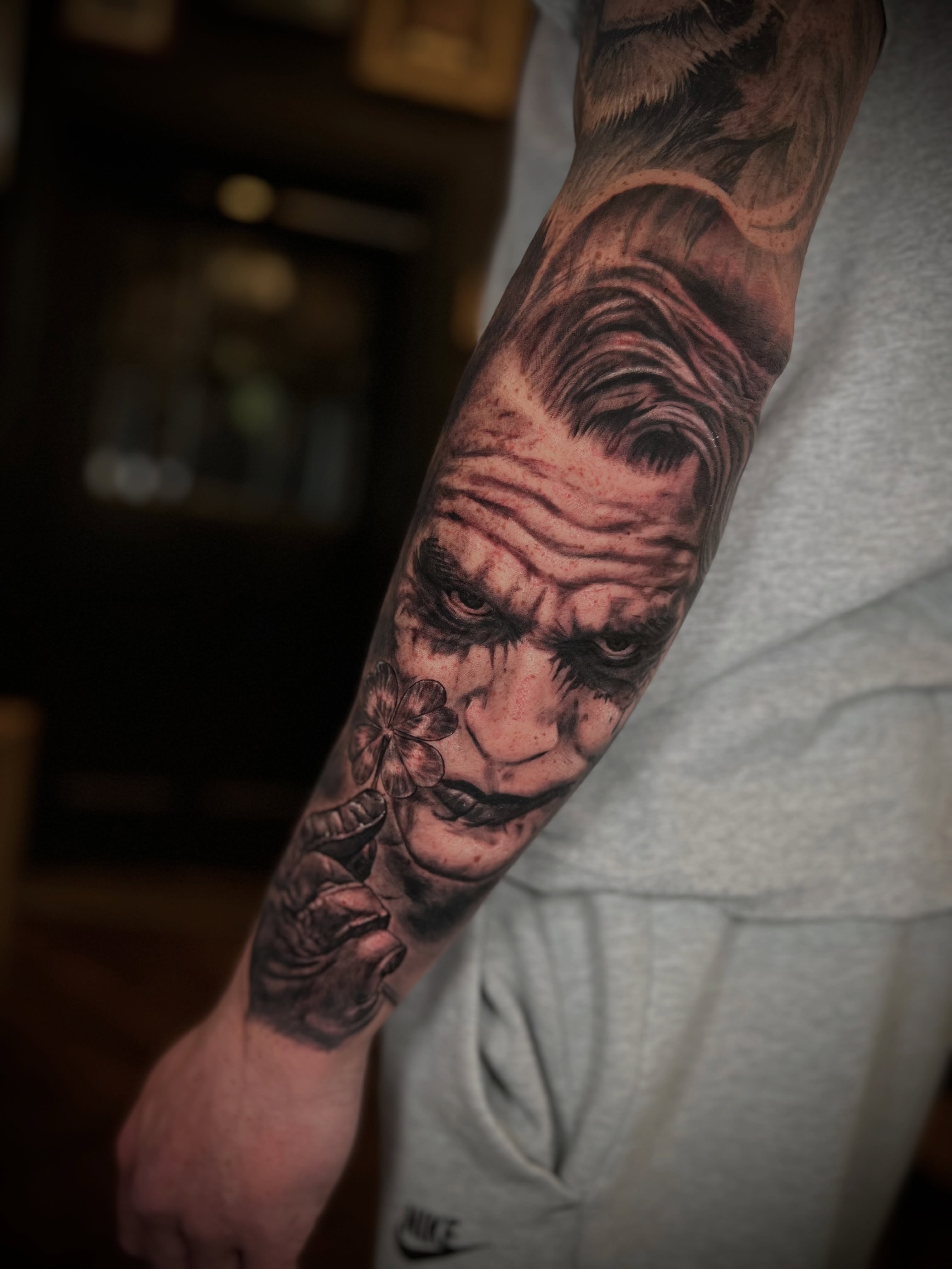 The Joker Holding a Flower Tattoo