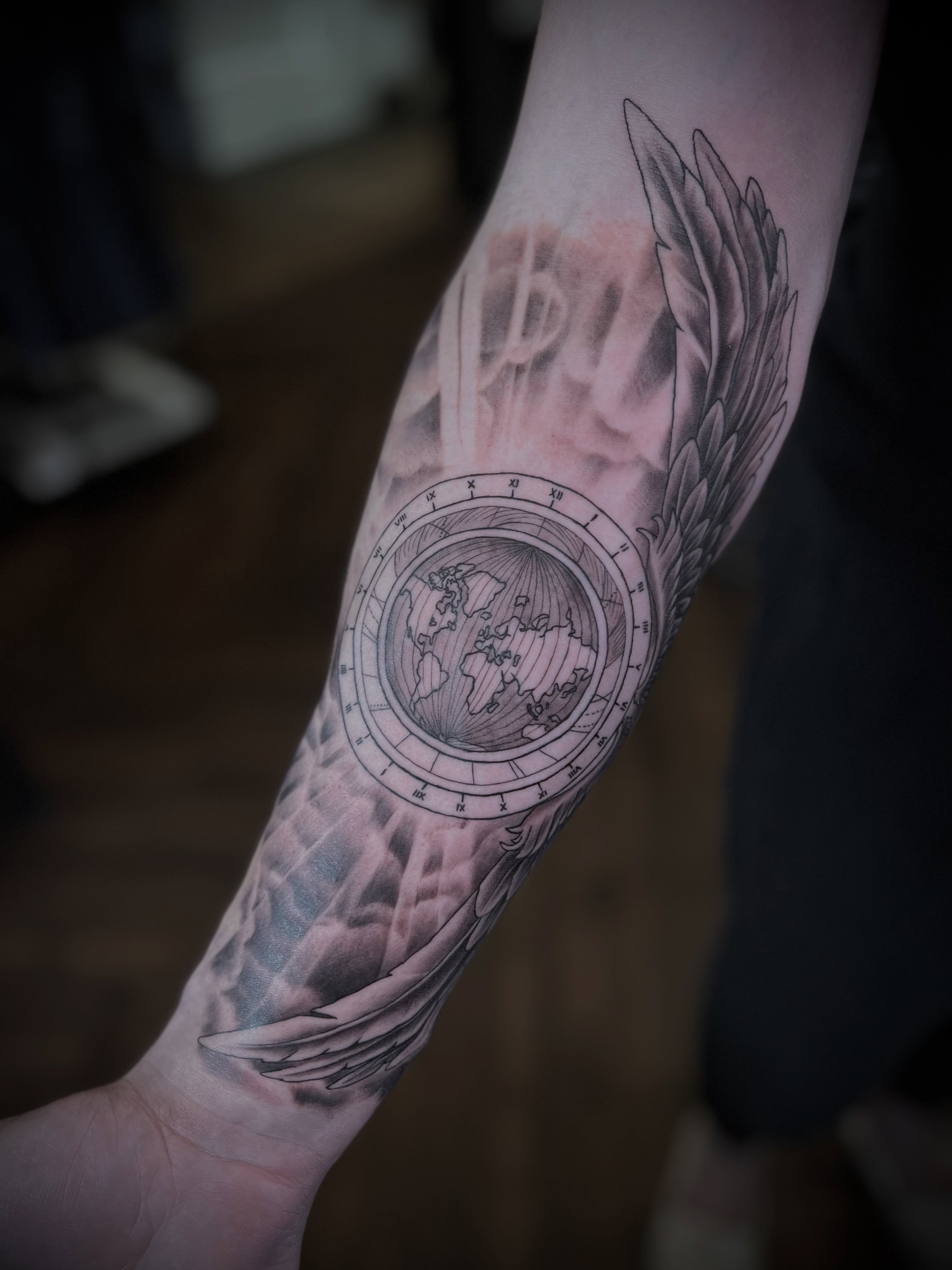 World Globe with Angel Wings Tattoo